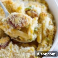 Bayou Cheesy Pasta Bake 5 Scooping out a spoon full of Cheesy Baked Cajun Pasta.