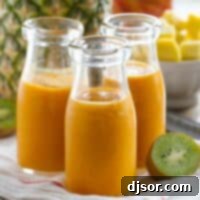 Golden Tropics Carrot Sip 4 A vibrant glass of Tropical Carrot Smoothie, ready to be enjoyed for a healthy treat.