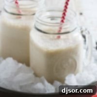 Creamy Root Beer Float Smoothie 4 Two jars filled with root beer float smoothie, each with a straw.