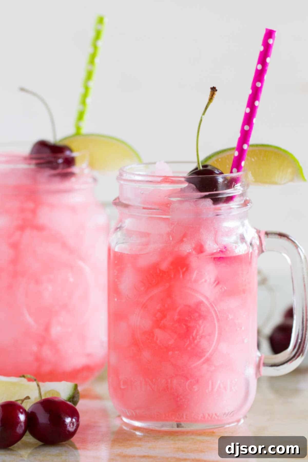 How to Make a Homemade Slurpee 2 Homemade Slurpees in glasses with lime slices, cherries, and straws