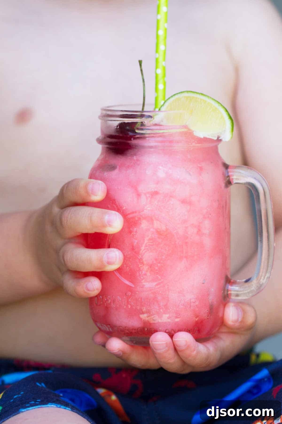 How to Make a Homemade Slurpee 3 A child holding a homemade Slurpee drink with a straw