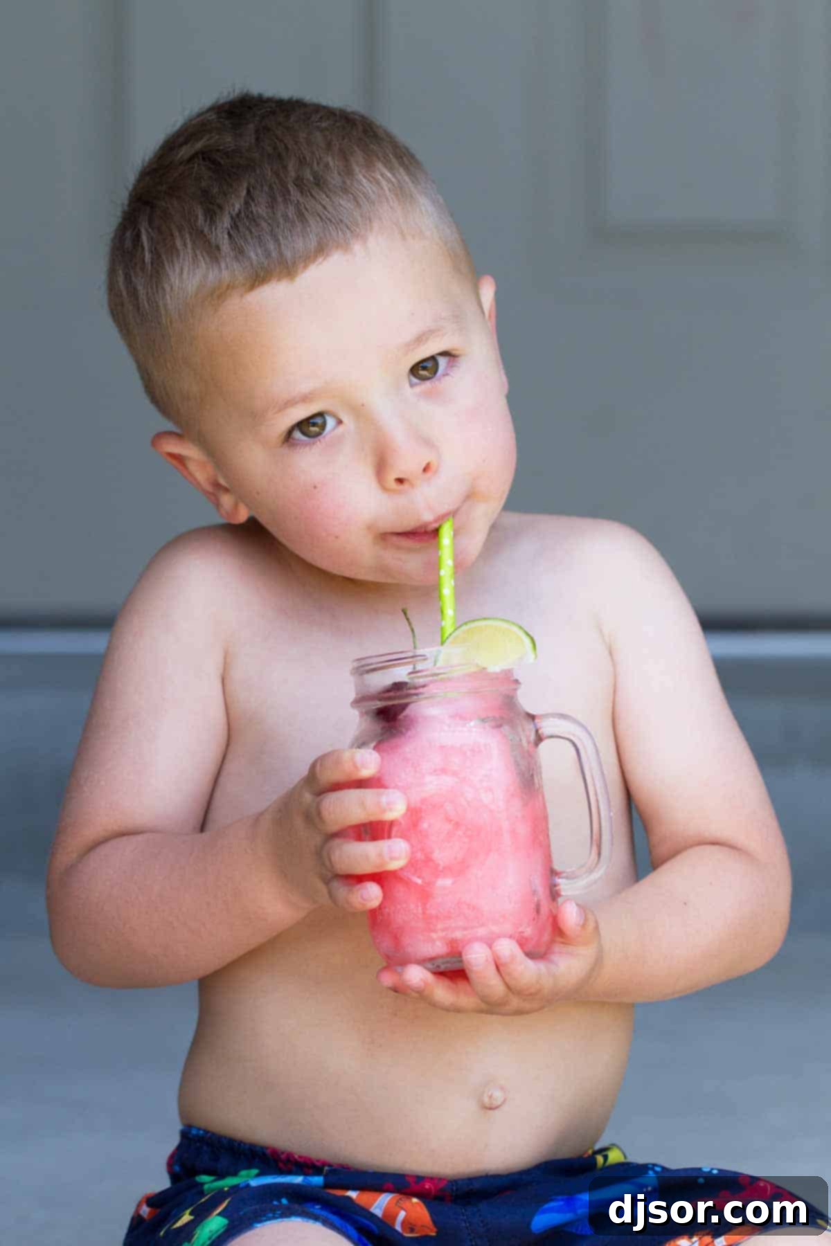How to Make a Homemade Slurpee 4 A child happily drinking a homemade Slurpee through a straw