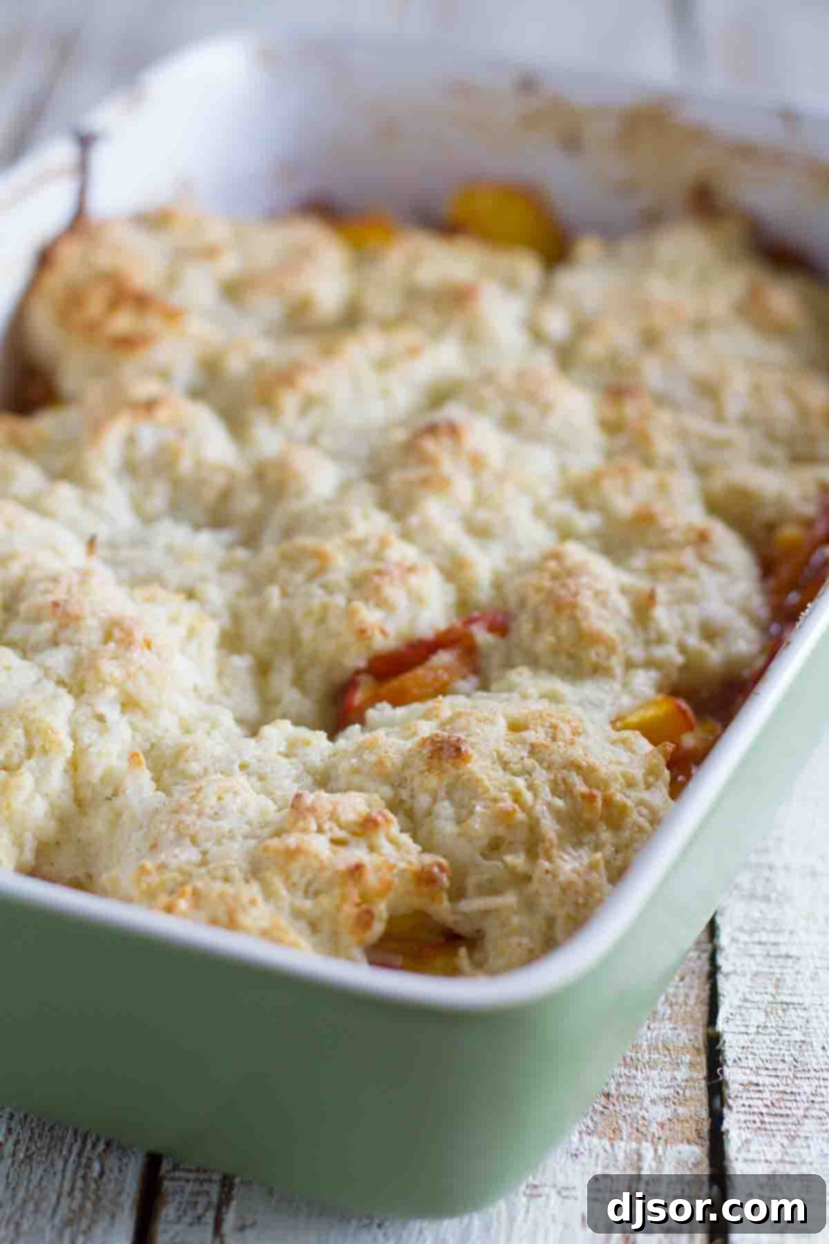 coconut and peach cobbler in a baking dish