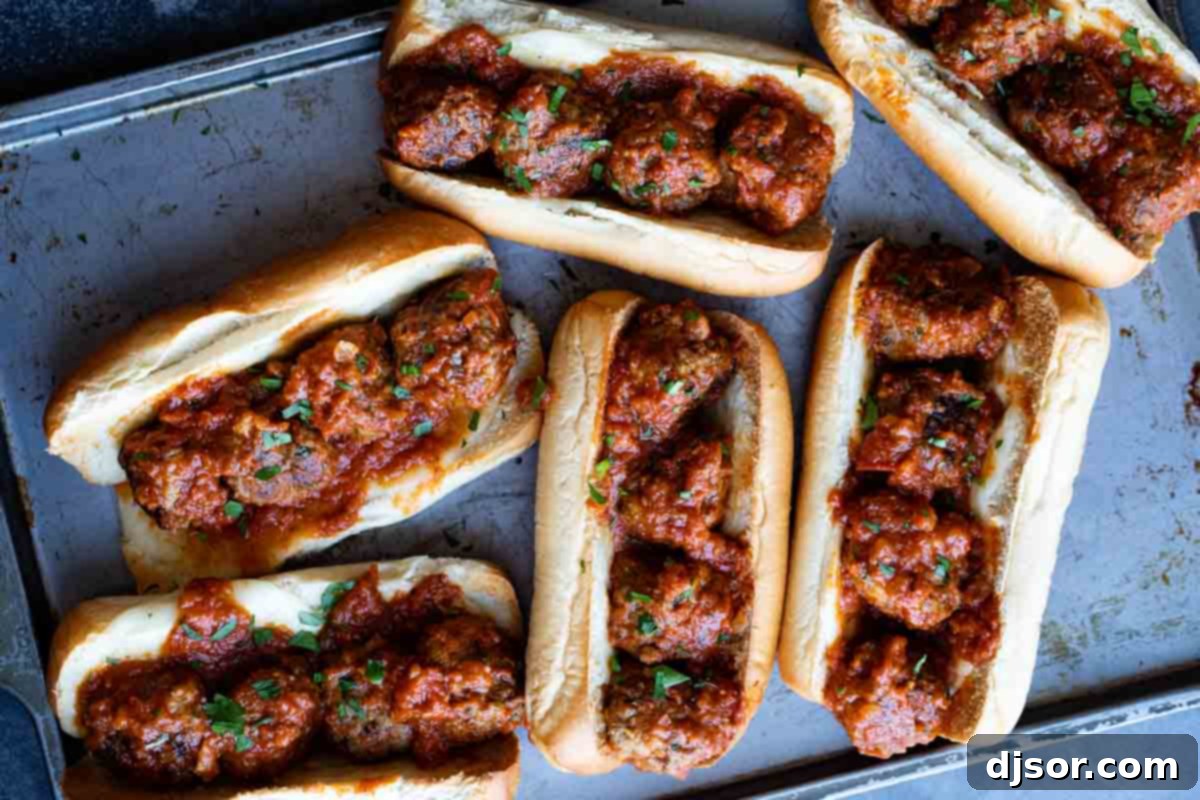 Close-up of a Hearty Homemade Meatball Sub Overhead close-up view of a freshly assembled homemade meatball sub, overflowing with juicy meatballs, rich marinara, and melted cheese.