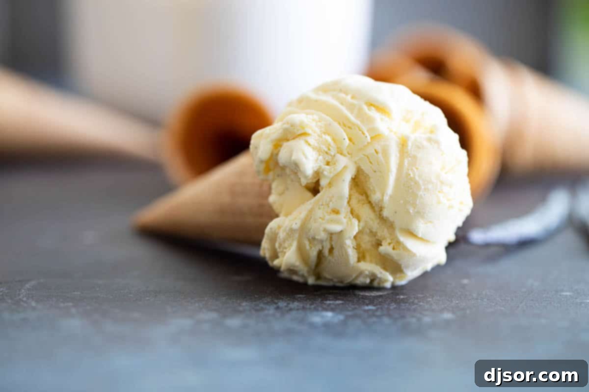 Scoop of vanilla ice cream in a sugar cone