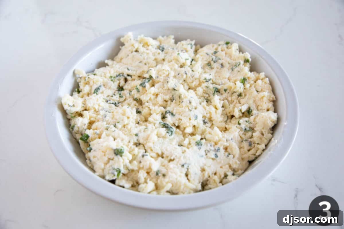 Creamy White Cheese Dip 6 Putting white cheese dip into a pie plate.