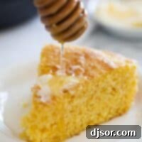 Honey being drizzled over a slice of cornbread.