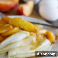 Easy Peaches and Cream Crepes 2 crepes filled with a cream cheese mixture and topped with sauteed peaches