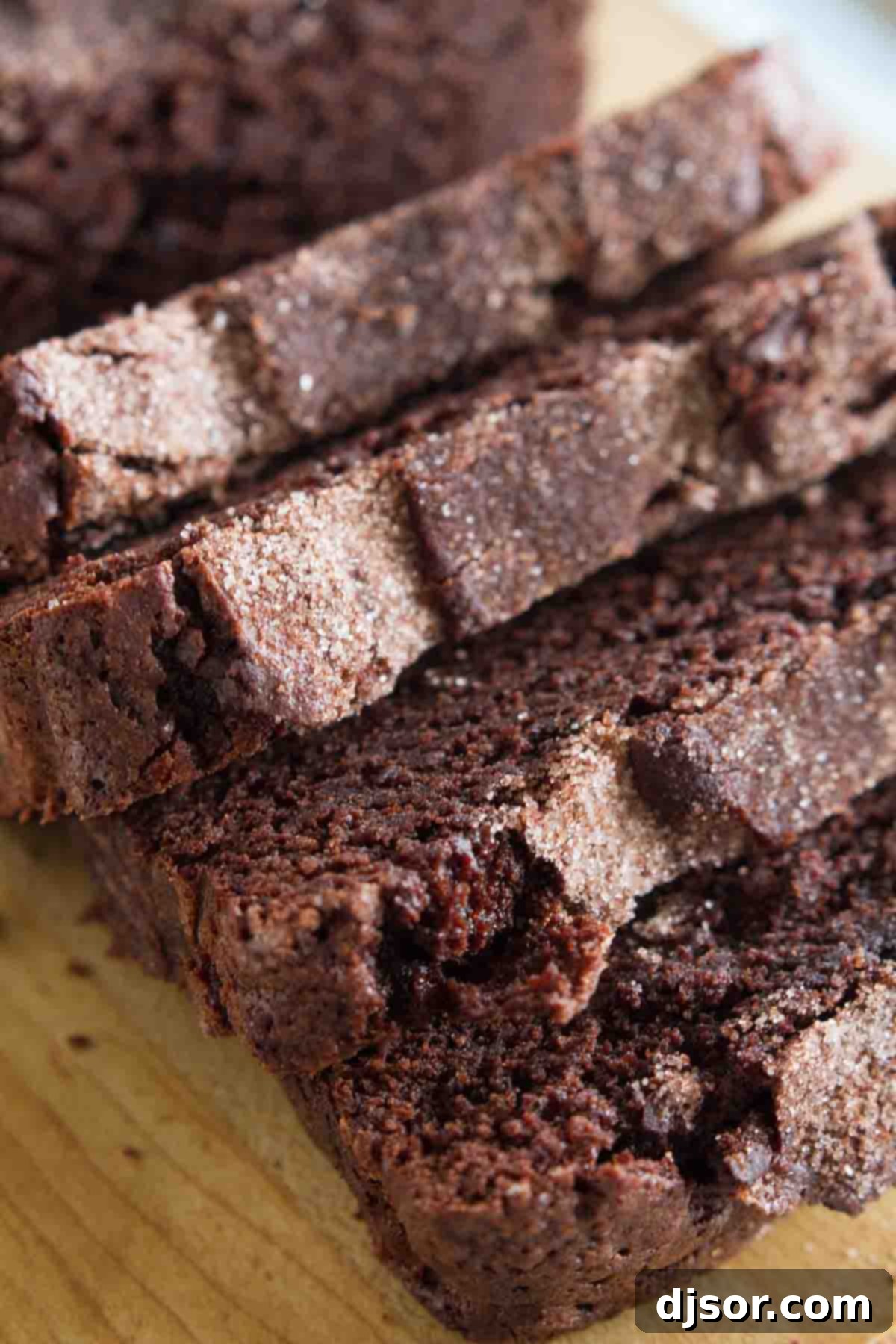 Chocolate Cinnamon Swirl Bread 3 A close-up shot revealing the moist, tender texture and rich chocolate swirls within a slice of chocolate cinnamon bread.