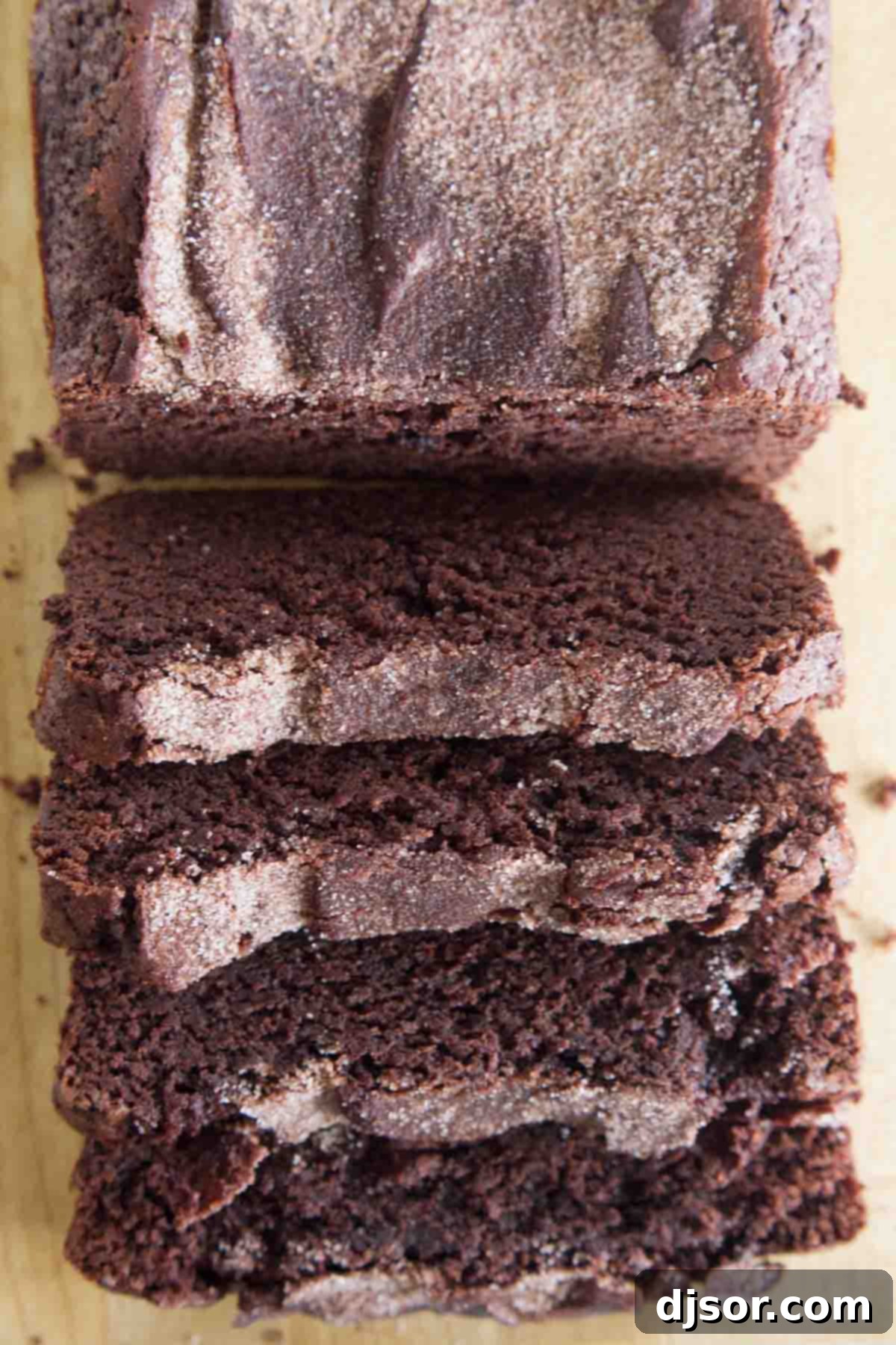 Chocolate Cinnamon Swirl Bread 4 An overhead view of two freshly baked loaves of chocolate cinnamon bread, one perfectly sliced, showcasing its enticing crumb and crunchy topping.