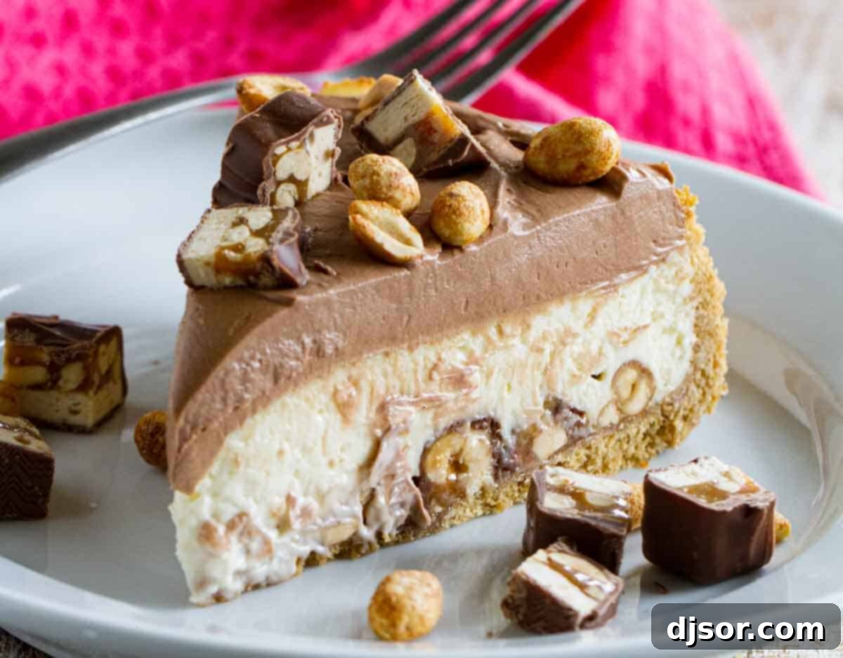 A delectable slice of Snickers cheesecake, showcasing its graham cracker crust, creamy filling studded with Snickers chunks, and a thick chocolate frosting, garnished with more candy and peanuts.
