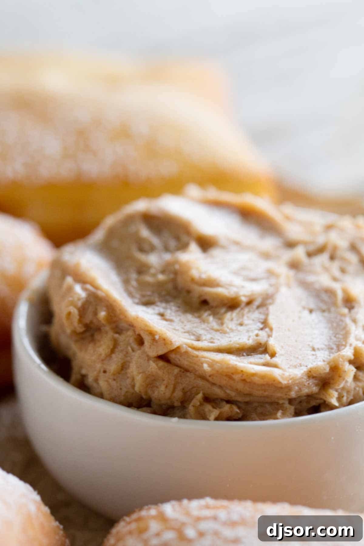 Not your typical scones served with tea, this German Scones Recipe is deep fried dough that is served with Cinnamon Honey Butter. bowl of cinnamon honey butter