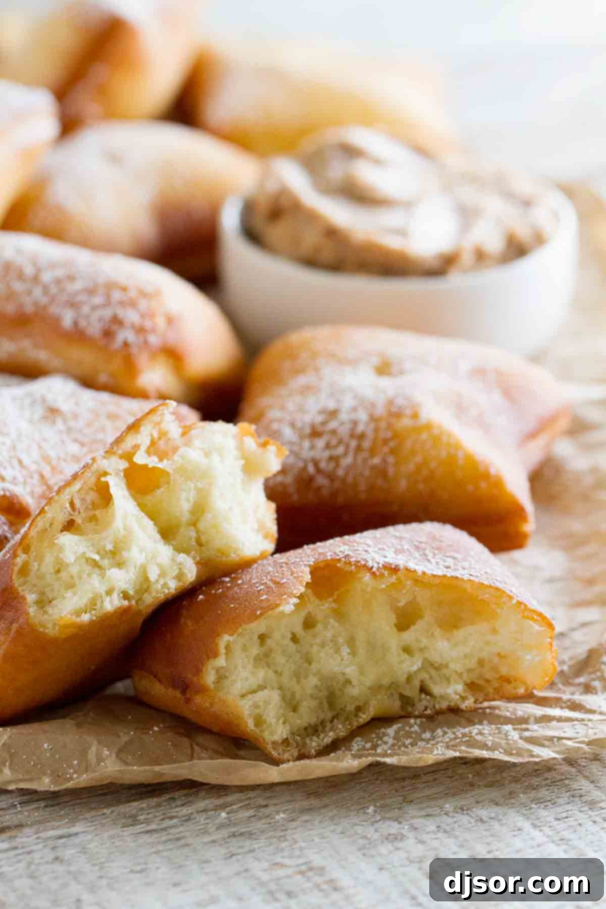 Not your typical scones served with tea, this German Scones Recipe is deep fried dough that is served with Cinnamon Honey Butter. German scones with one in half to show texture of inside