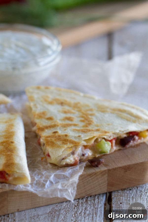 Ready to serve: Perfectly grilled and sliced Greek Quesadilla. A sliced Greek quesadilla presented on a cutting board, ready to be served.