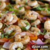 chopped vegetables and shrimp cooked on a sheet pan