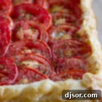 Tomato tart with bacon and gruyere on puff pastry.