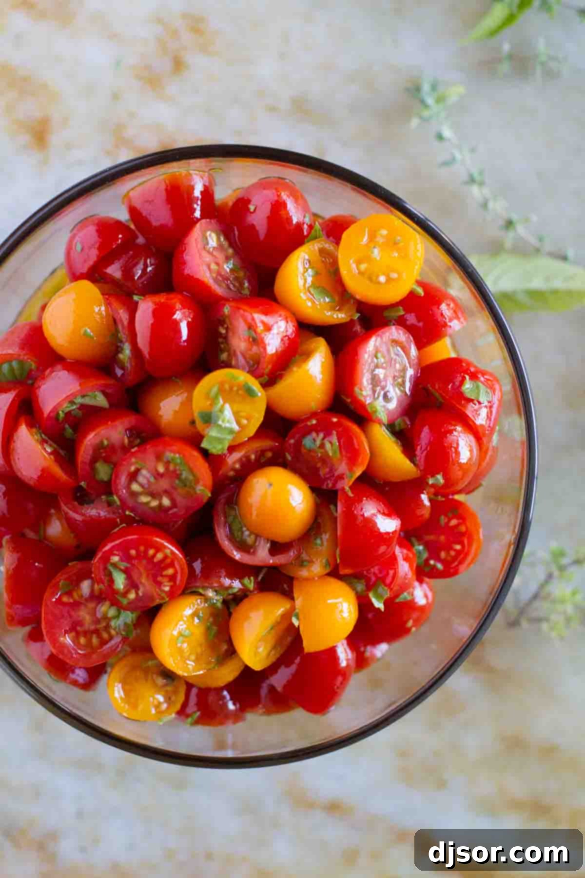 Prepping Herbed Tomato Salad: Simple Ingredients, Maximum Flavor An overhead view of halved grape tomatoes glistening with olive oil, ready to be tossed with fresh herbs in a simple and delicious Herbed Tomato Salad.
