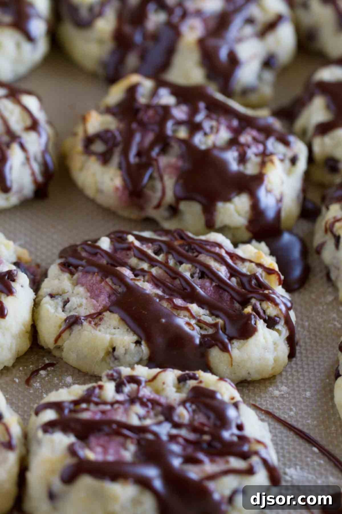 Delicious chocolate chip biscuits with raspberry cream, topped with a tempting chocolate drizzle, perfect for a sweet breakfast or dessert