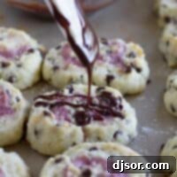 drizzling chocolate over a chocolate chip biscuit