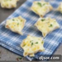Cheesy Corn Bites topped with cilantro, on a towel over a baking sheet.