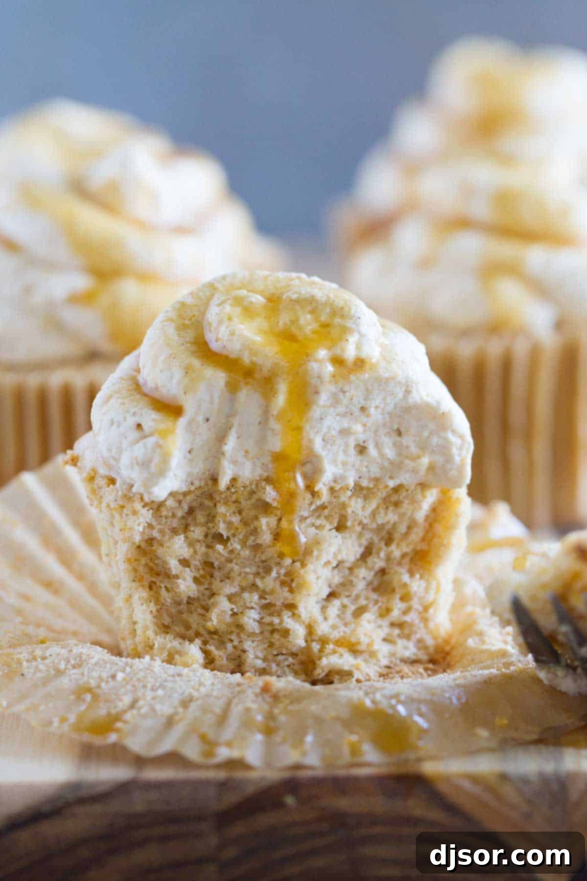 Pumpkin Cloud Cupcakes 5 A close-up shot of a Pumpkin Angel Food Cupcake with a bite taken out, revealing its incredibly light and airy interior.
