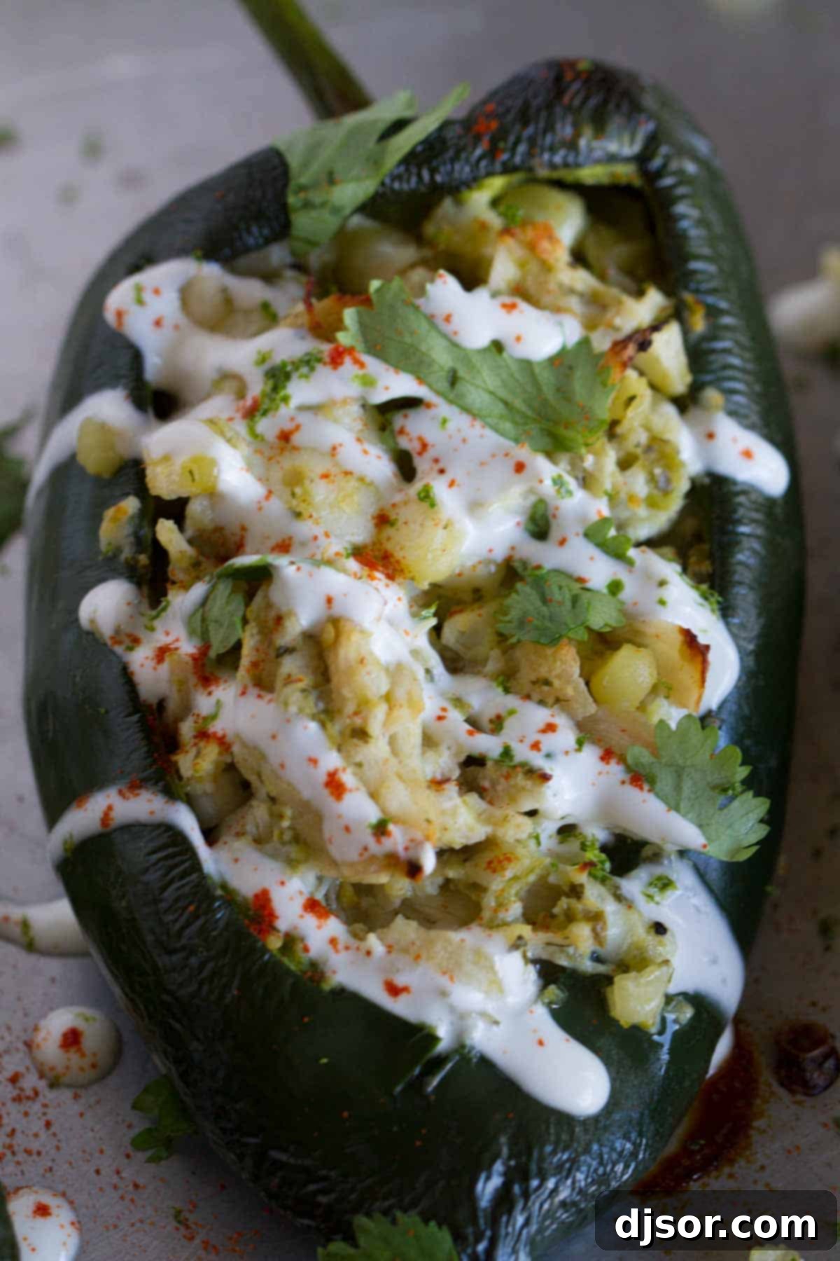 Hearty Chicken and Corn Stuffed Poblano Peppers 2 Close-up shot showing the rich texture of a poblano chile stuffed generously with golden corn, tender shredded chicken, and melted, bubbly cheese. The vibrant colors and textures promise a delicious bite.