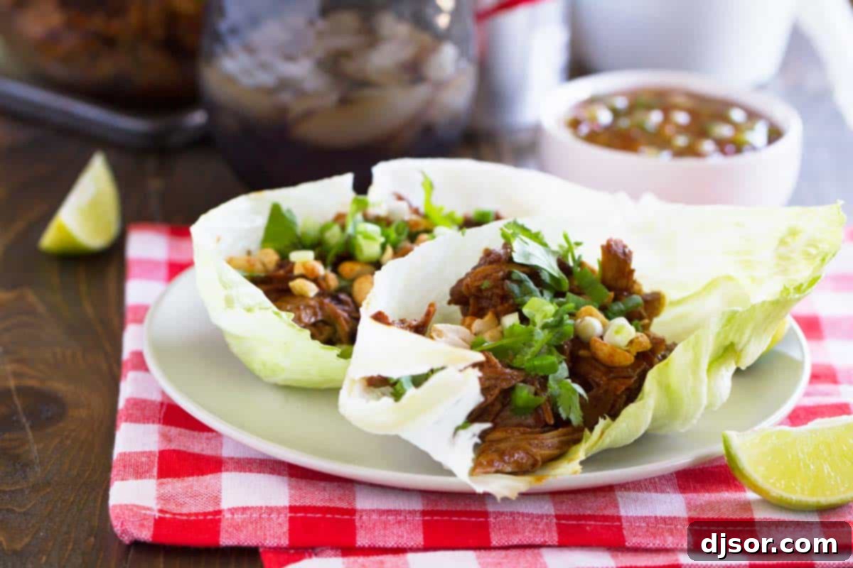 Smoky BBQ Pork Lettuce Cups 2 BBQ Pork Lettuce Wraps topped with peanuts, green onions, and cilantro.