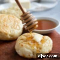 Drizzling honey onto crumpets.