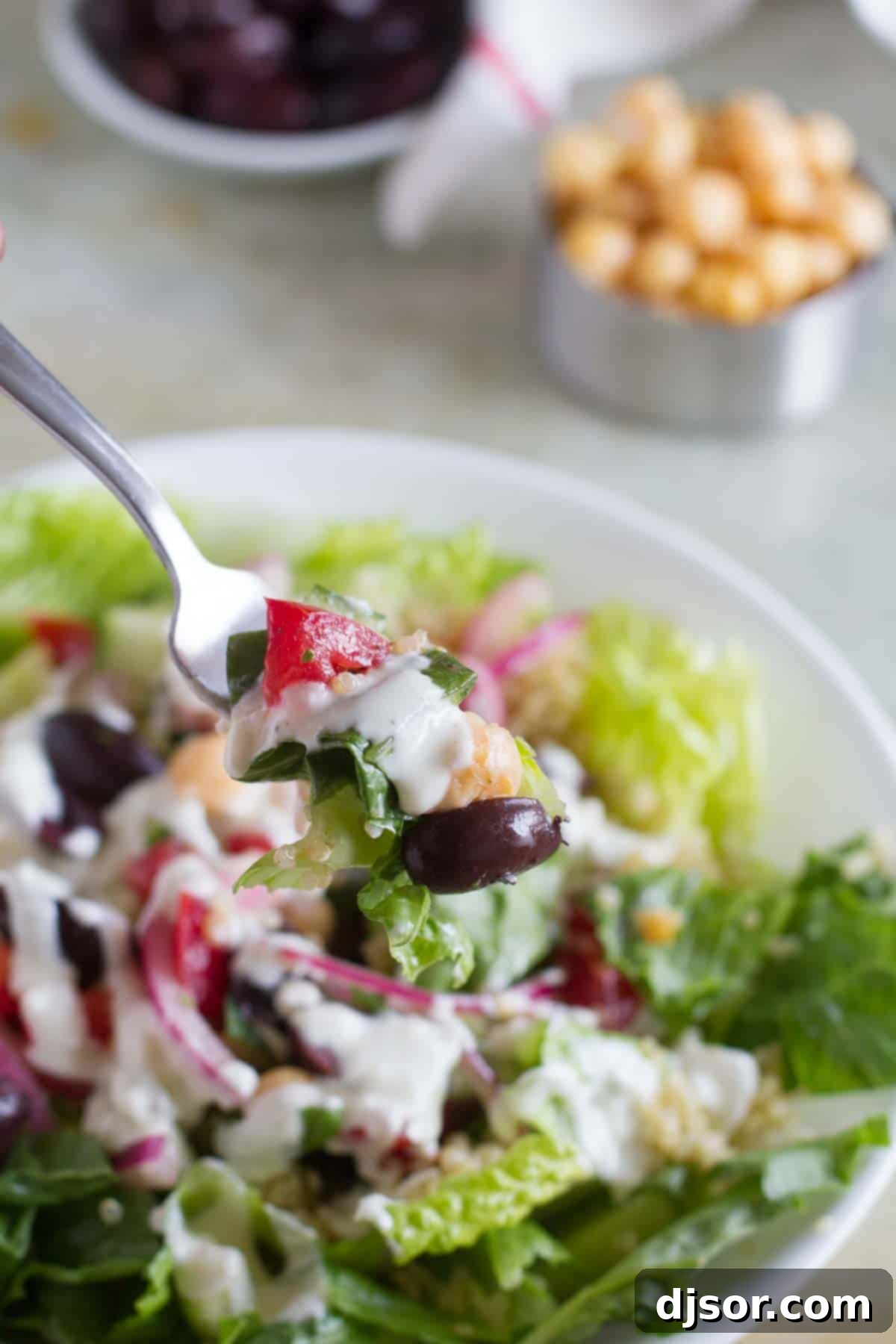 Vibrant Greek Quinoa Bowl 4 Fork full of Greek Quinoa Salad.