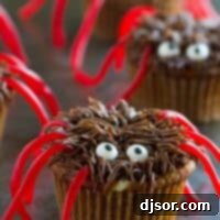 Pumpkin Cheesecake Spider Cupcakes on a surface.
