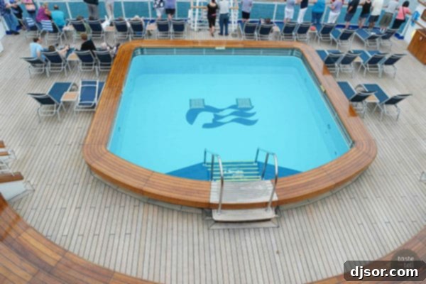 Ruby Princess Royal Voyage 7 Ruby Princess ship interior with elegant staircases and chandelier, reflecting the ship's classic design.