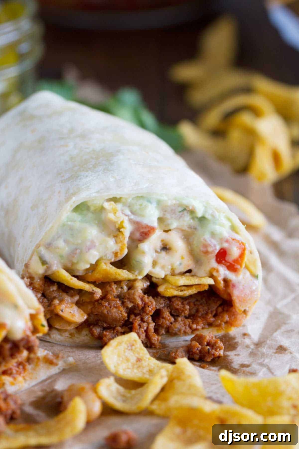 Frito Crunch Chili Burrito 4 Close-up view of a Frito Pie Burrito showing the abundant filling of chili, Fritos, pico de gallo, and green chile queso.