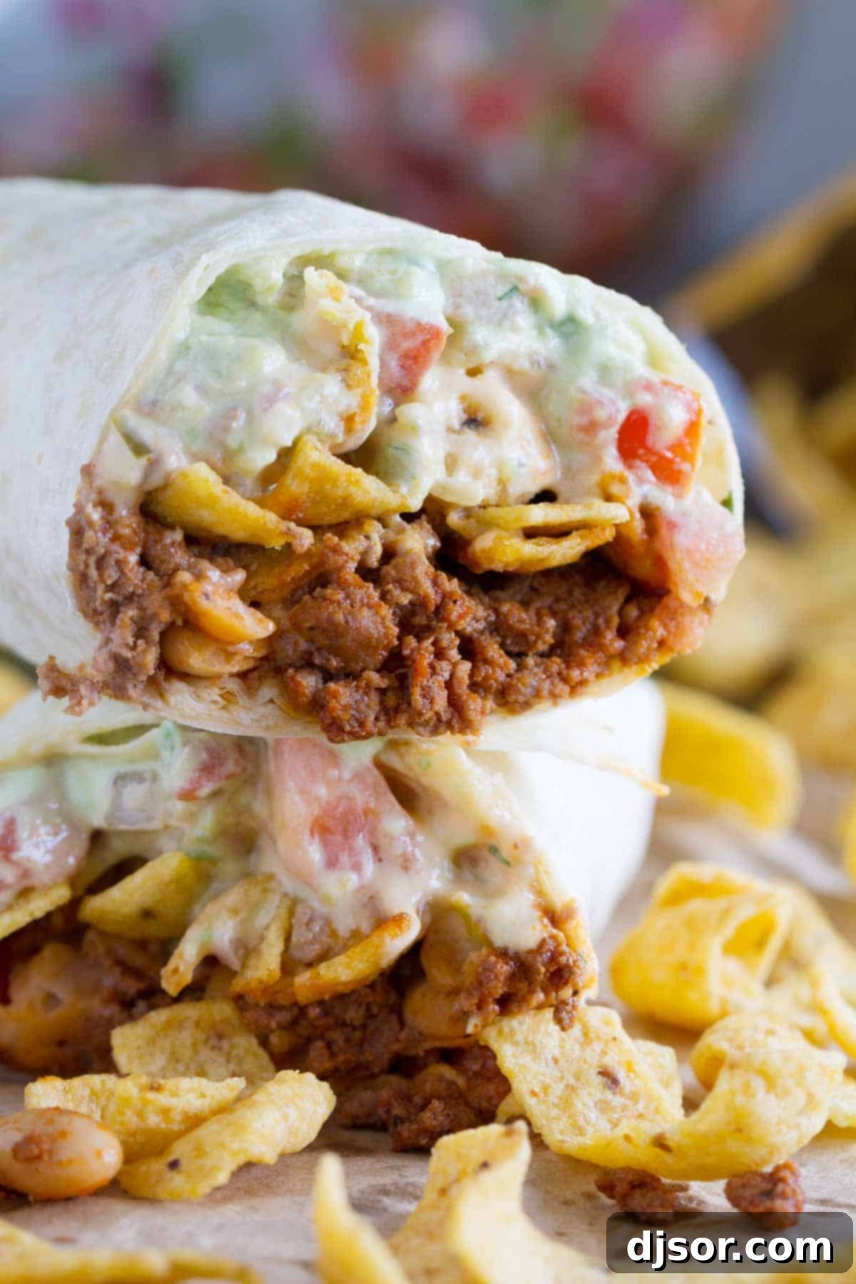 Frito Crunch Chili Burrito 5 Two halves of a Frito Pie Burrito, stacked to showcase the rich, layered interior.
