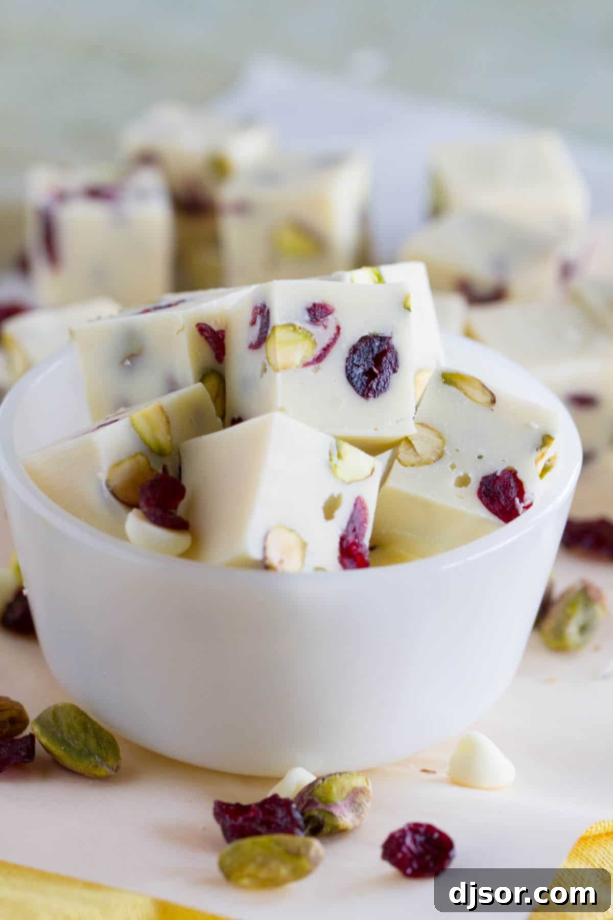 Slices of Creamy Cranberry Pistachio Fudge in a small bowl.