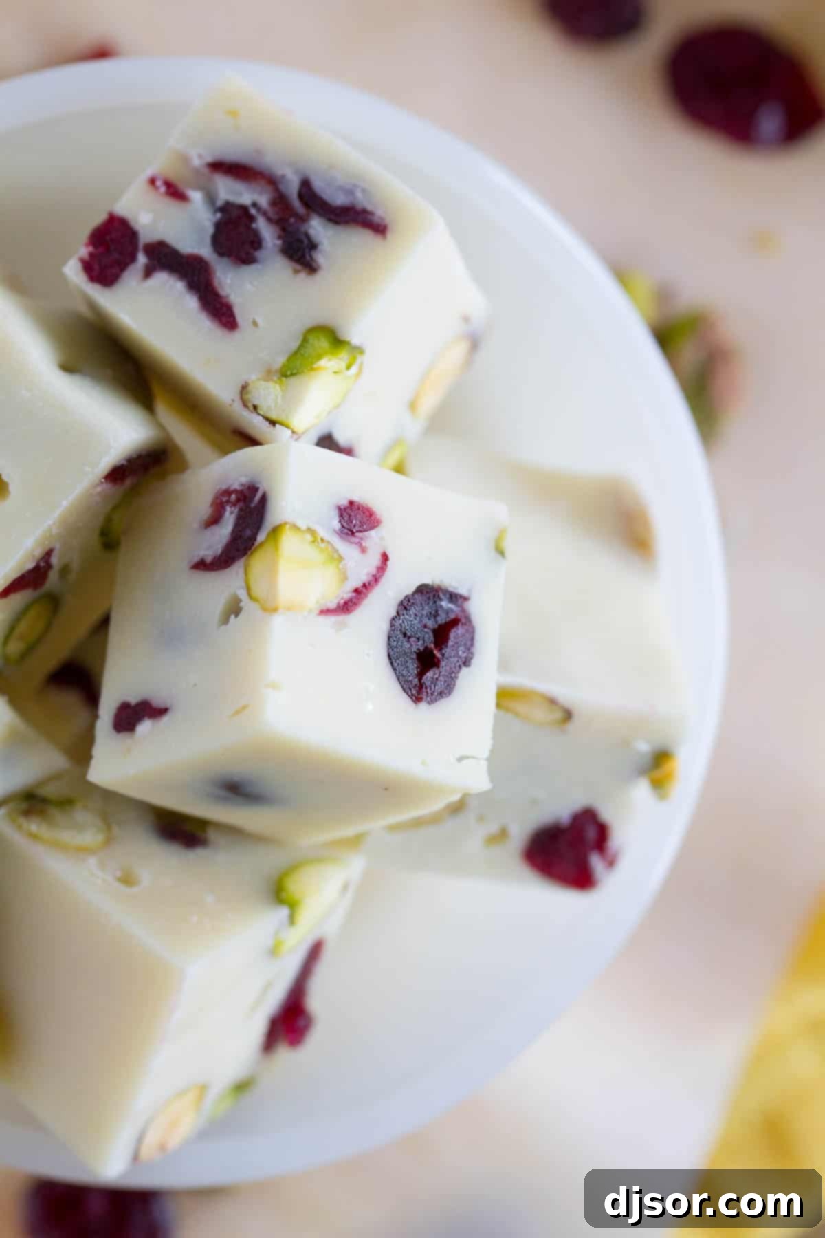 slices of cranberry pistachio fudge, showing texture and nuts and fruit.