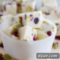 Slices of Creamy Cranberry Pistachio Fudge in a small bowl.