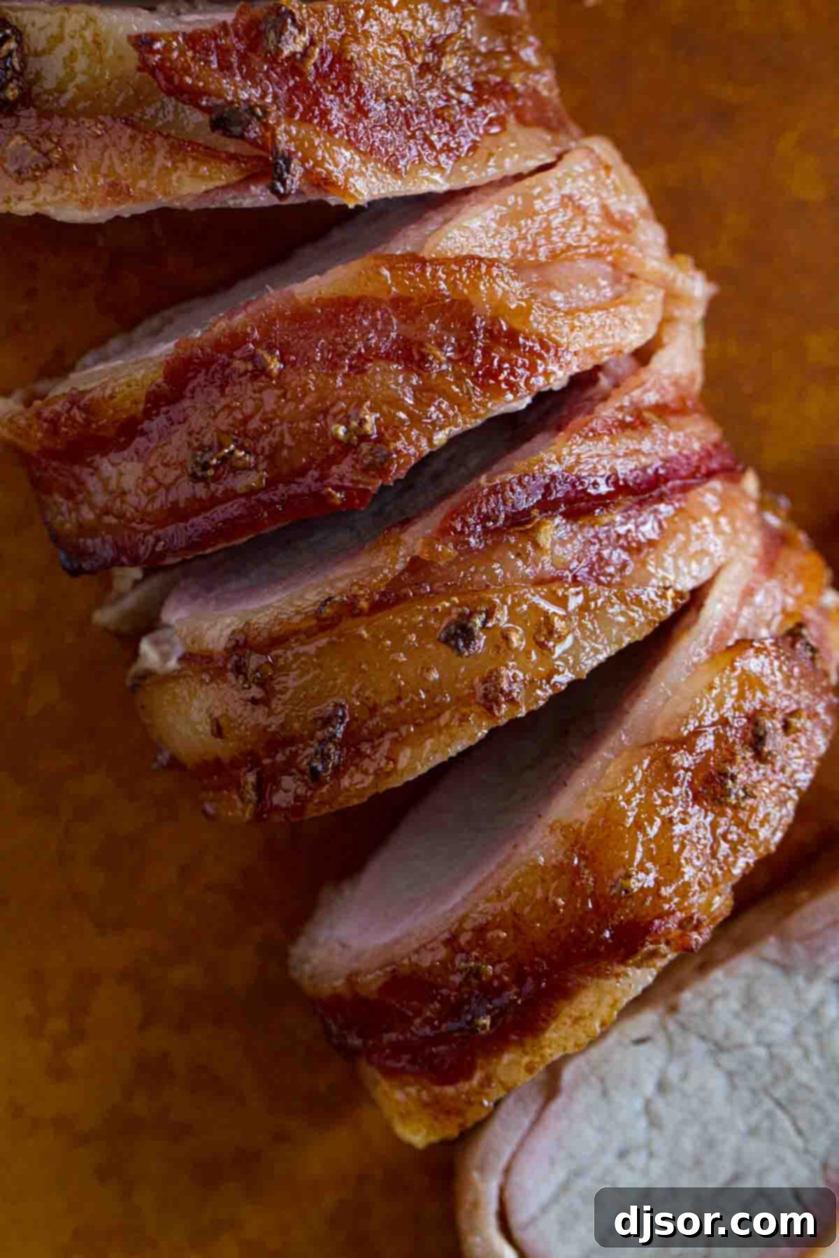 Overhead view of a perfectly cooked Bacon Wrapped Pork Tenderloin