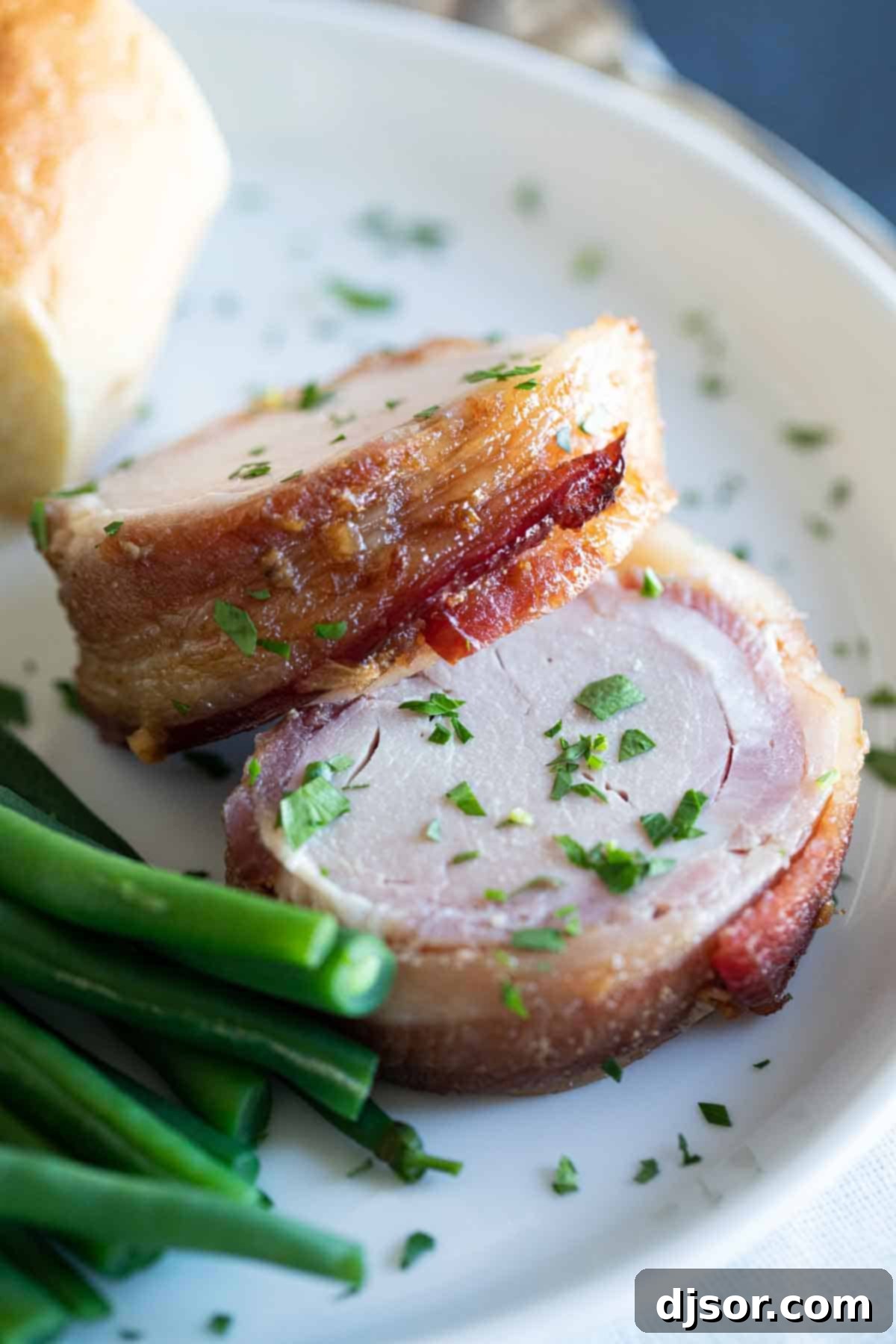 Bacon Wrapped Pork Tenderloin plated beautifully, ready to enjoy
