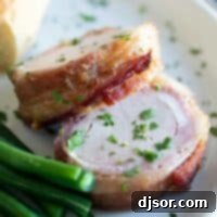 Pork tenderloin wrapped in bacon on a plate