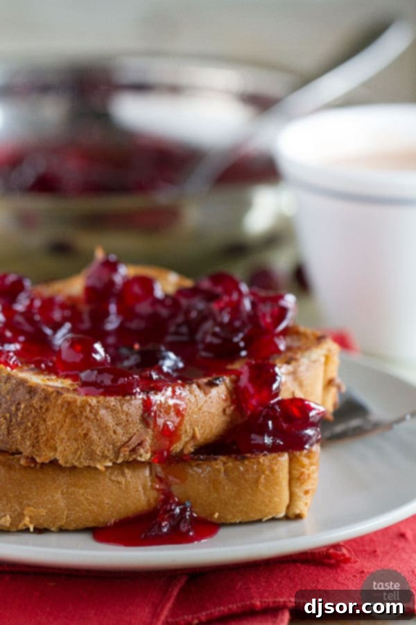 Golden-brown Coconut Crusted Oven Baked French Toast drizzled with vibrant Cranberry Syrup, a perfect dairy-free and egg-free breakfast.