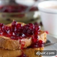 Coconut Crusted Oven Baked French Toast with Cranberry Syrup, a dairy-free and egg-free breakfast masterpiece.