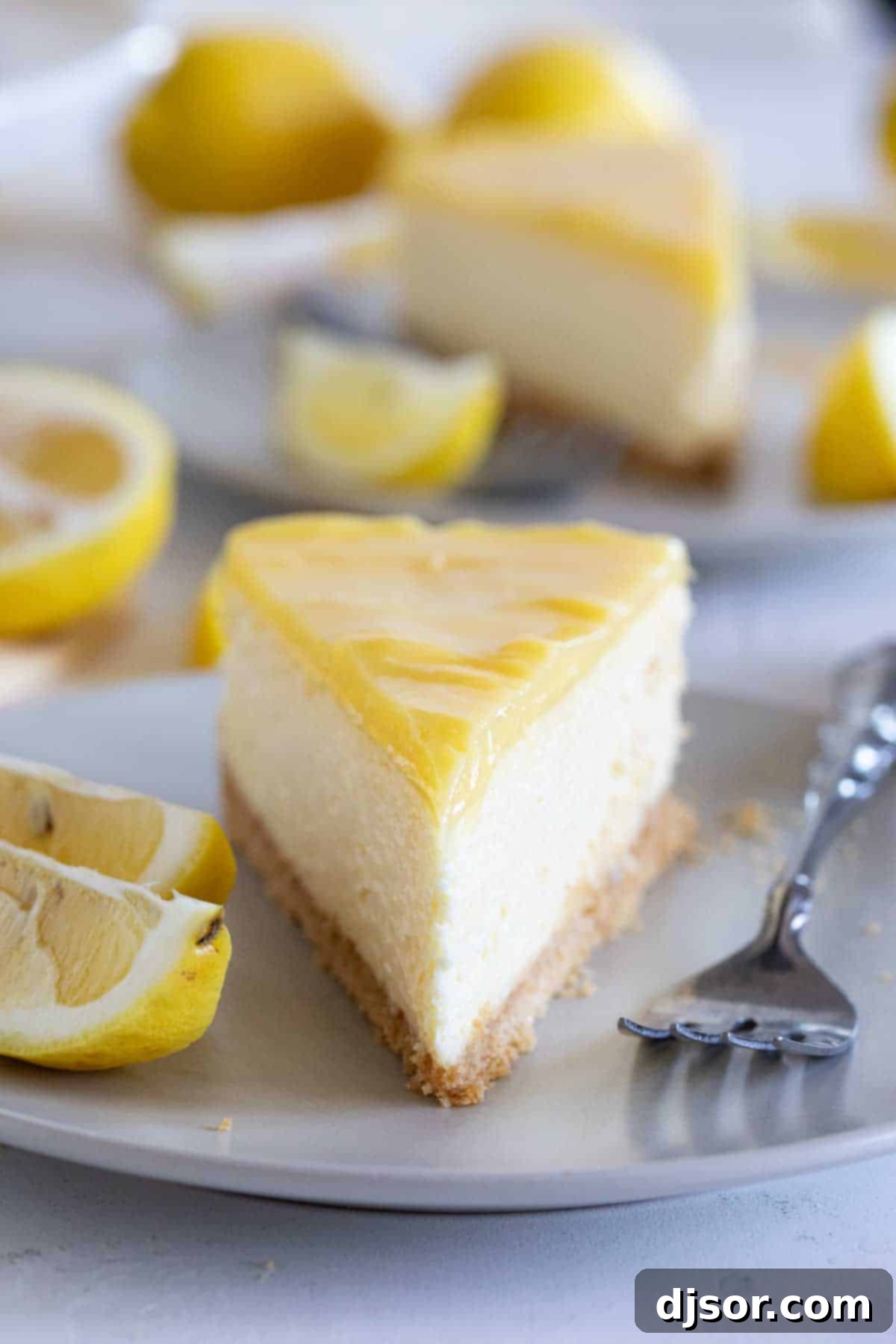 A beautiful display of multiple slices of lemon cheesecake, garnished with a fresh lemon twist, ready to be enjoyed.