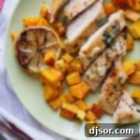 Zesty Lemon Chicken with Roasted Butternut 2 Beautifully plated lemon chicken and roasted butternut squash, drizzled with pan juices, and garnished with a grilled lemon half and fresh oregano.