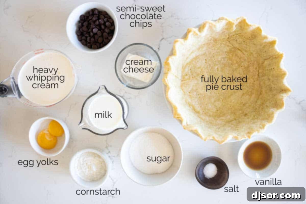 Essential Ingredients for Your Perfect Chocolate Cream Pie Ingredients laid out on a table, including sugar, cornstarch, milk, chocolate chips, egg yolks, cream cheese, and heavy cream.