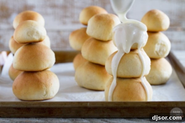 Sunset Snowman's Odyssey 5 Perfectly baked Orange Snowman Rolls, generously coated with a creamy orange glaze