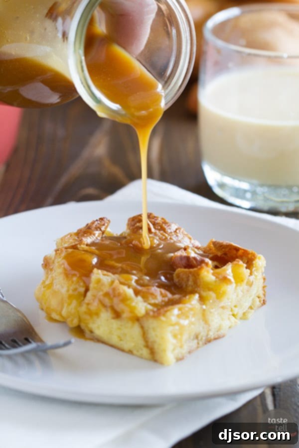 A serving of Eggnog Croissant Bread Pudding, perfectly golden, with a generous drizzle of the rich Caramel Eggnog Syrup.