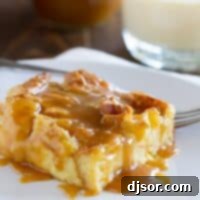 A beautiful plate of Eggnog Croissant Bread Pudding with a generous drizzle of Caramel Eggnog Syrup.