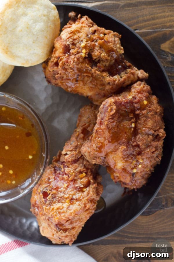 Hot Honey Fried Chicken and Biscuits A Taste Test Review 5 A spread of Honey Fried Chicken, golden buttermilk biscuits, and a small bowl of spicy hot honey sauce, ready to be enjoyed.