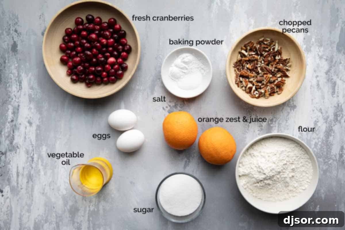 fresh ingredients for cranberry orange bread including cranberries, oranges, eggs, oil, and flour