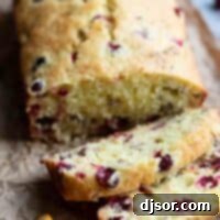 slices of cranberry orange bread with fresh cranberries